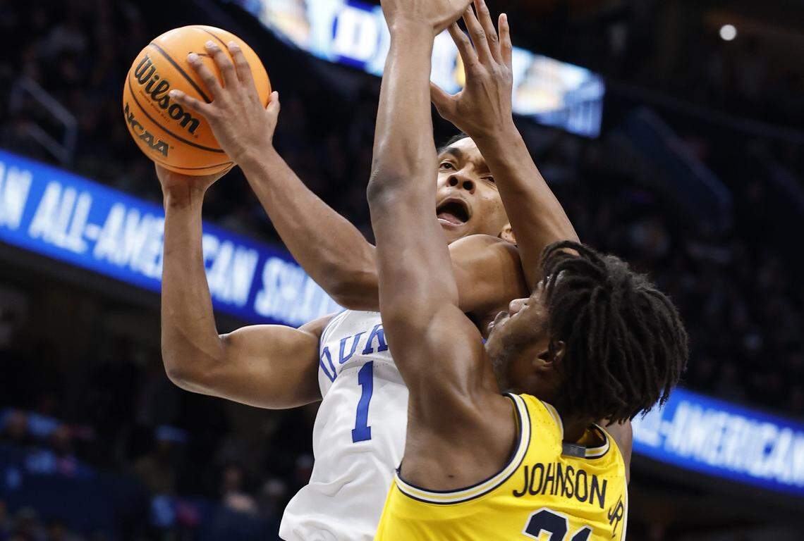 Duke’s Caleb Foster (1) heads to the basket defended by Michigan's Morez Johnson Jr. (21) during the first half of Duke’s game against Michigan in the Capital Showcase at Capital One Arena in Washington, D.C., Saturday, Feb. 21, 2026.