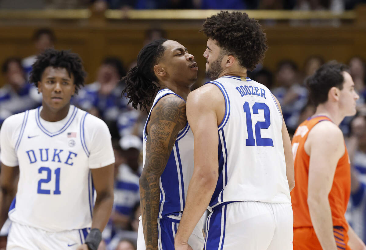 Duke’s Isaiah Evans (3) and Cameron Boozer (12) bump chests during the second half of Duke’s 67-54 victory over Clemson at Cameron Indoor Stadium in Durham, N.C., Sat., Feb. 14, 2026.