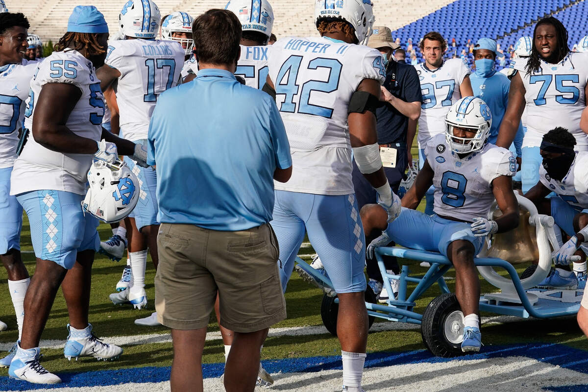 North Carolina Tar Heels players celebrate keeping the victory bell after the win over the Duke Blue Devils at Wallace Wade Stadium. Mandatory Credit: 