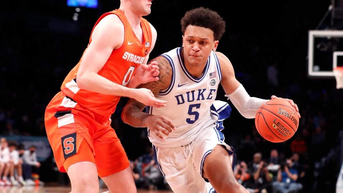 Dukes Paolo Banchero (5) drives past Syracuse’s Jimmy Boeheim (0) during the second half of Dukes 88-79 victory over Syracuse in the quarterfinals of the ACC mens basketball tournament at the Barclays Center in Brooklyn, N.Y., Thursday, March 10, 2022.