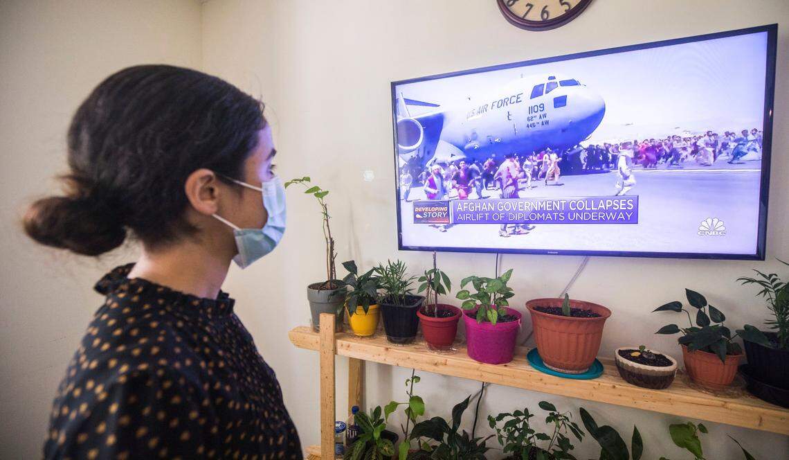 Fatema Mohammadi watches a video posted online from her apartment in Durham, N.C. of people surrounding a U.S. Air Force plane as it takes off from the airport in Kabul, Afghanistan on Monday, Aug. 16, 2021.