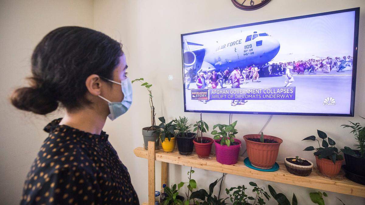 Fatema Mohammadi watches a video posted online from her N.C. apartment of people surrounding a U.S. Air Force plane as it takes off from the airport in Kabul, Afghanistan on Monday, Aug. 16, 2021.