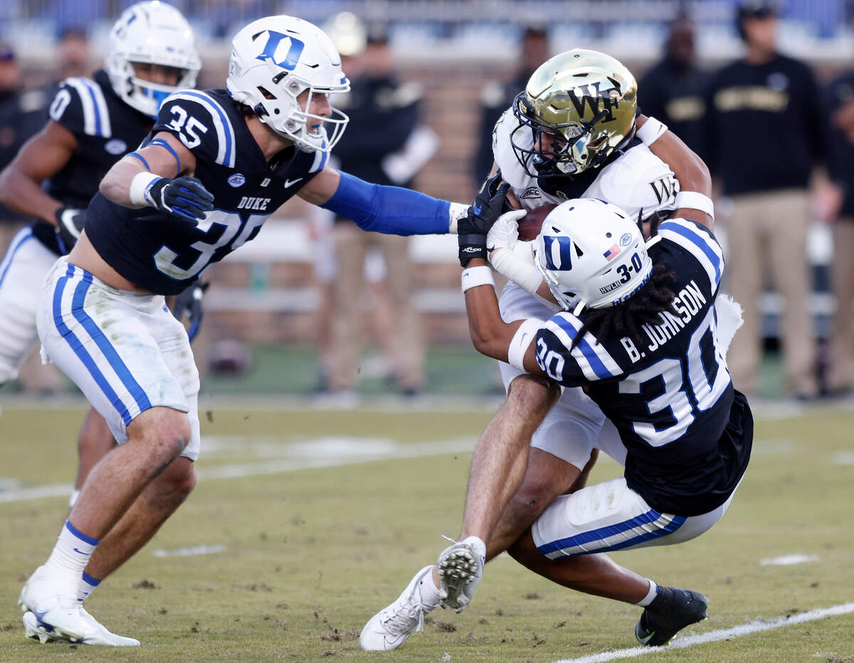 Duke’s Brandon Johnson tackles Wake Forest’s Taylor Morin during the first half of the Blue Devils’ final regular season game at Wallace Wade Stadium on Saturday, Nov. 26, 2022, in Durham, N.C.