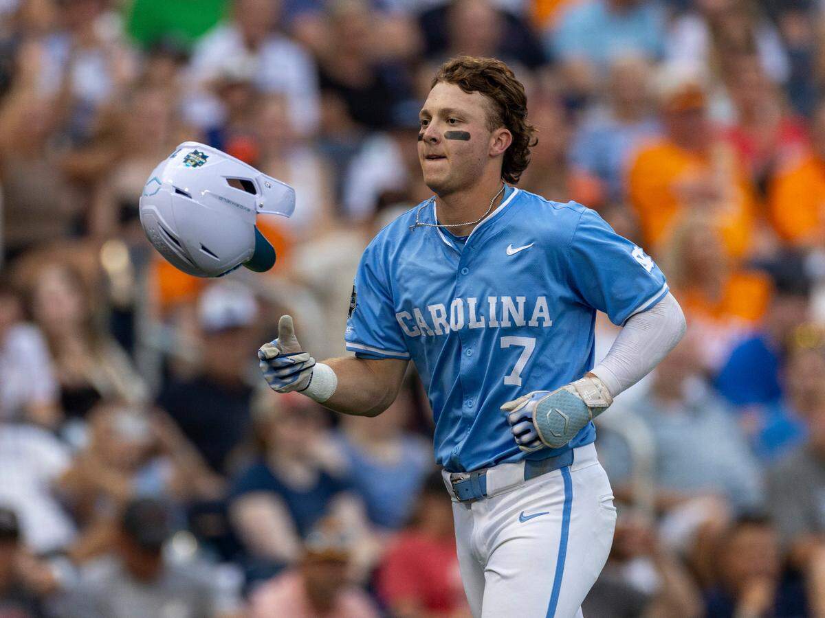 North Carolina outfielder Vance Honeycutt (7) flips his batting helmet after connecting for a home run in the sixth inning against Tennessee during the College World Series on Sunday, June 16, 2024 at Charles Swab Field in Omaha, Nebraska.