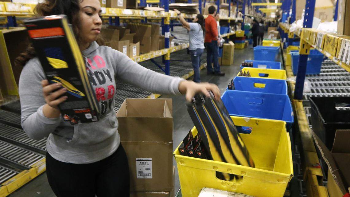 Specialty line picker Juana Rivera fills an order for custom insoles for a retail customer in the warehouse section of Implus, which sells foot footwear and outdoors accessories to retailers around the world. The company has a 135,000 square foot facility in Durham.