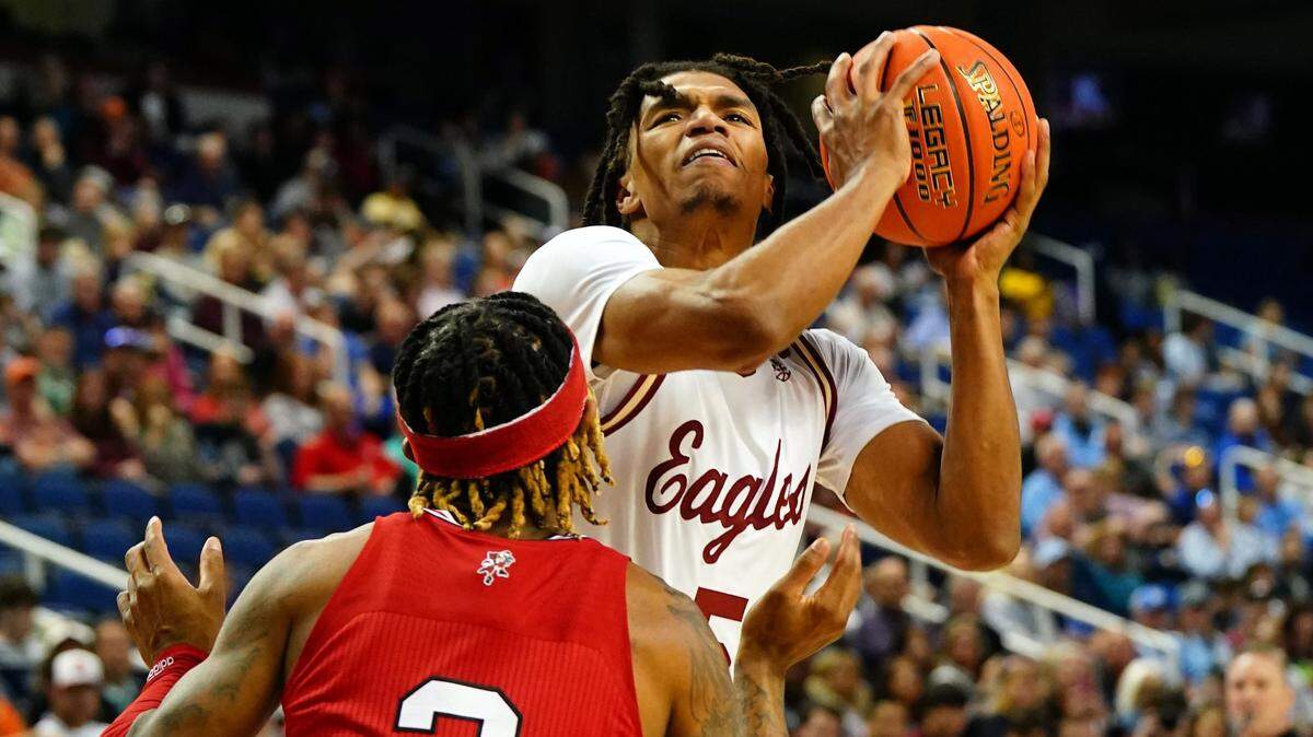 Mar 7, 2023; Greensboro, NC, USA; Boston College Eagles guard DeMarr Langford Jr. (5) drives to the basket against Louisville Cardinals guard El Ellis (3) during the first half of the first round of the ACC tournament at Greensboro Coliseum. Mandatory Credit: John David Mercer-USA TODAY Sports