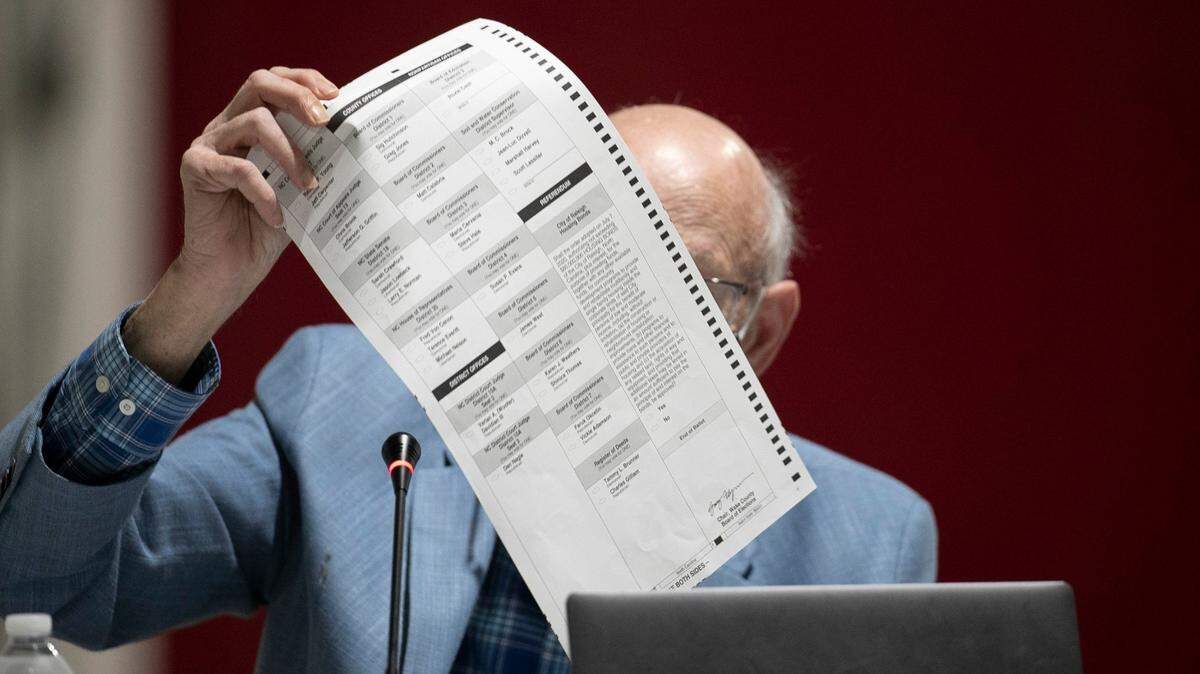 Wake County Board of Elections member Gerry Cohen reviews ballots on Friday, November 13, 2020 at the Wake County Board of Elections in Raleigh, N.C.