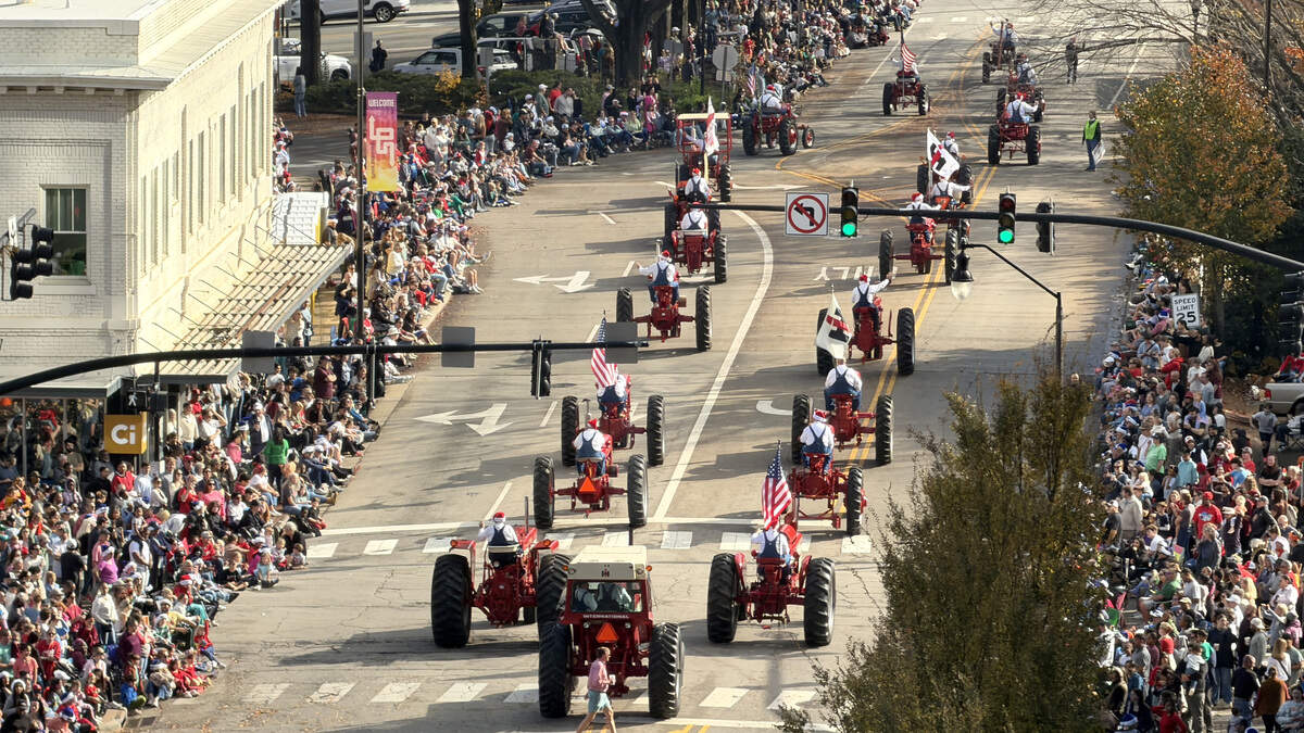 Participants in the Raleigh Christmas Parade march down Hillsborough Street in Raleigh, N.C. Saturday morning, Nov. 22, 2025.