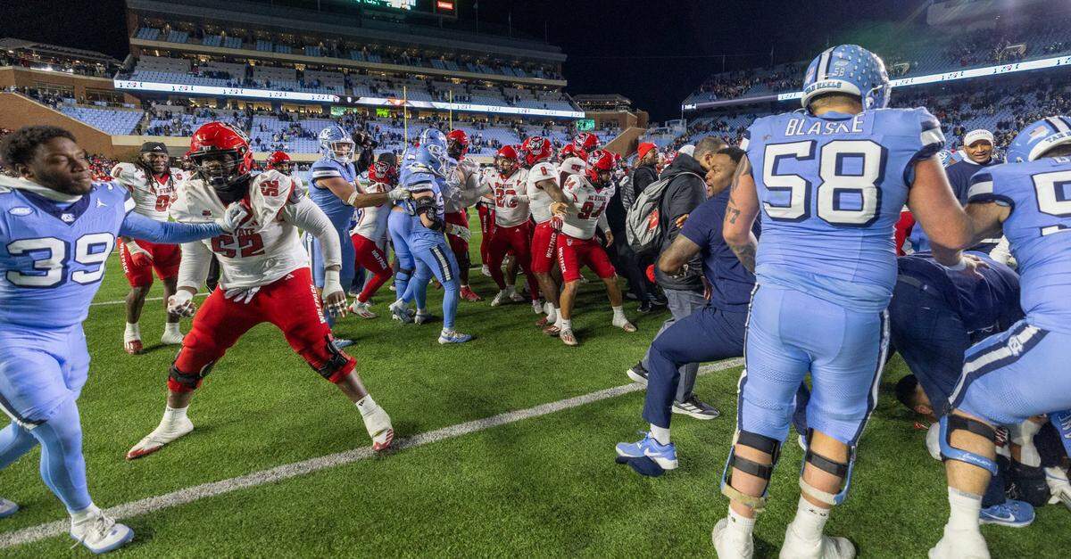 North Carolina defensive back Major Byrd (39) mixes it up with N.C. State offensive guard Timothy McKay (52) during an altercation between the team following the Wolfpack’s 35-30 victory on Saturday, November 30, 2024 at Kenan Stadium in Chapel Hill, N.C.