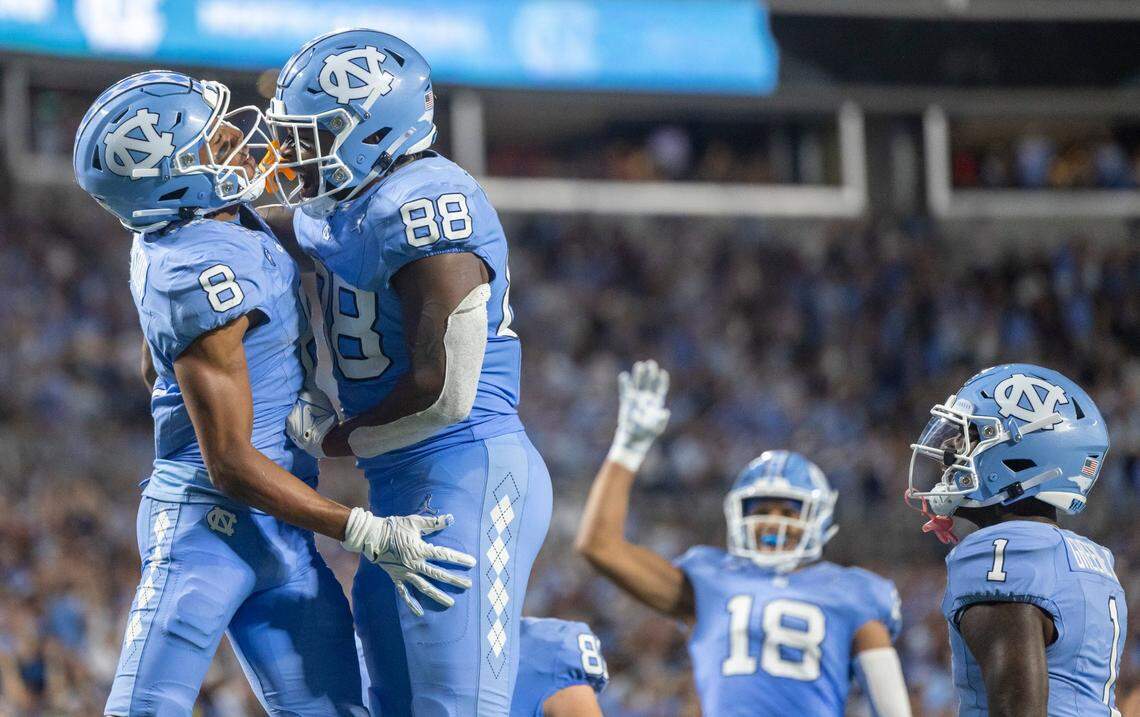 North Carolina’s Kobe Paysour (8) celebrates with teammate Kamari Morales (88) after scoring a touchdown on a 34-yard pass from quarterback Drake Maye two give the Tar Heels a 17-14 lead in the second quarter on Saturday September 2, 2023 at Bank of America Stadium in Charlotte, N.C.