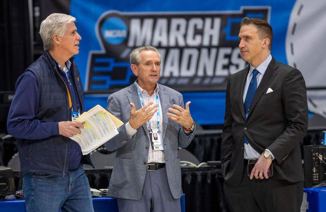 CBS analysts Jim Spanarkle, left and Jon Rothstein, talk with North Carolina athletic director Bubba Cunningham during the North Carolina practice ahead of their First Four game against Sane Diego State in the NCAA Tournament on Monday, March 17, 2025 in Dayton, Ohio.