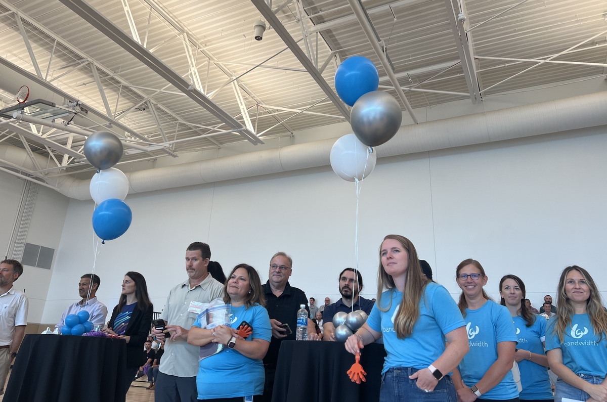Bandwidth employees, referred internally as “bandmates,” celebrate their company’s new headquarters in west Raleigh on Friday, August 4, 2023. 