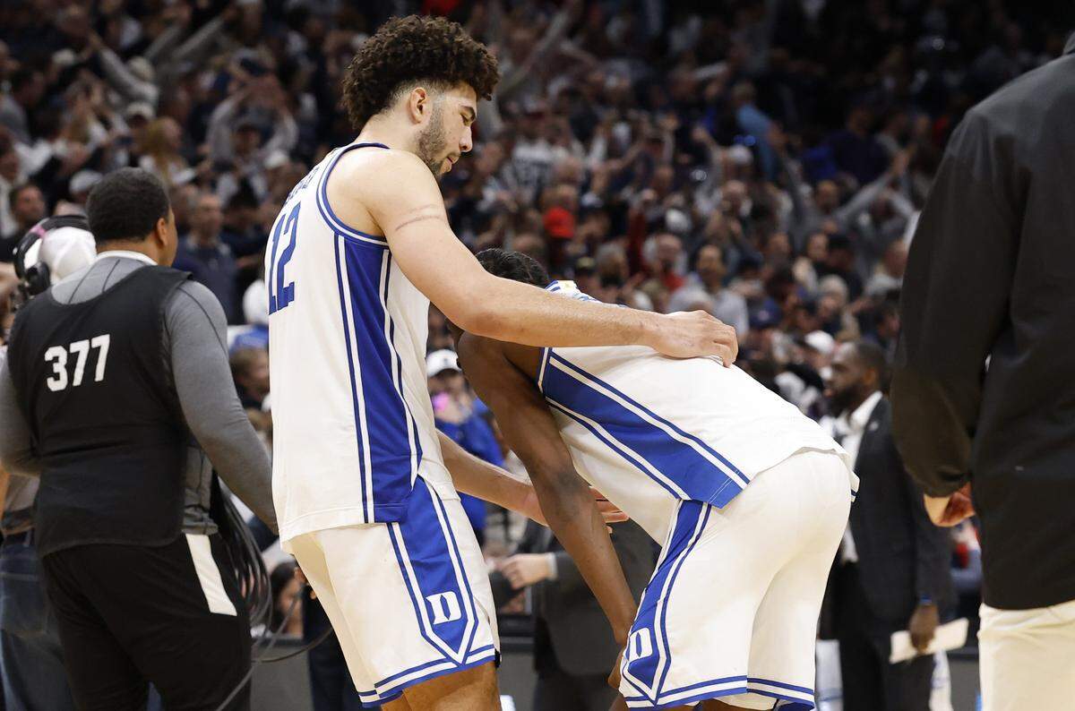 Duke’s Cameron Boozer (12) heads to comfort Dame Sarr (7) after UConn’s 73-72 victory over Duke in the NCAA Men’s Tournament East Regional Final at Capital One Arena in Washington, D.C., Sunday, March 29, 2026.