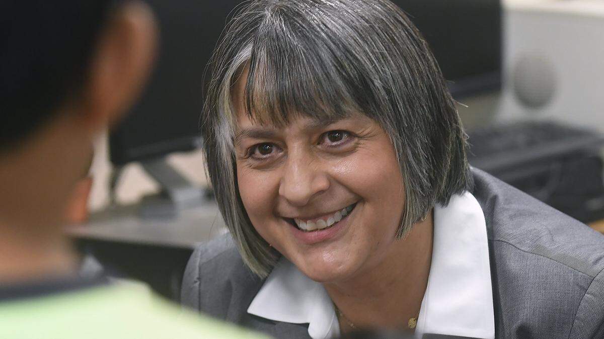 Wake County schools superintendent Catty Moore smiles as she speaks with a student at Fuller Elementary School in this 2018 file photo. Moore used to go by Cathy but has returned to using her legal first name of Catty.