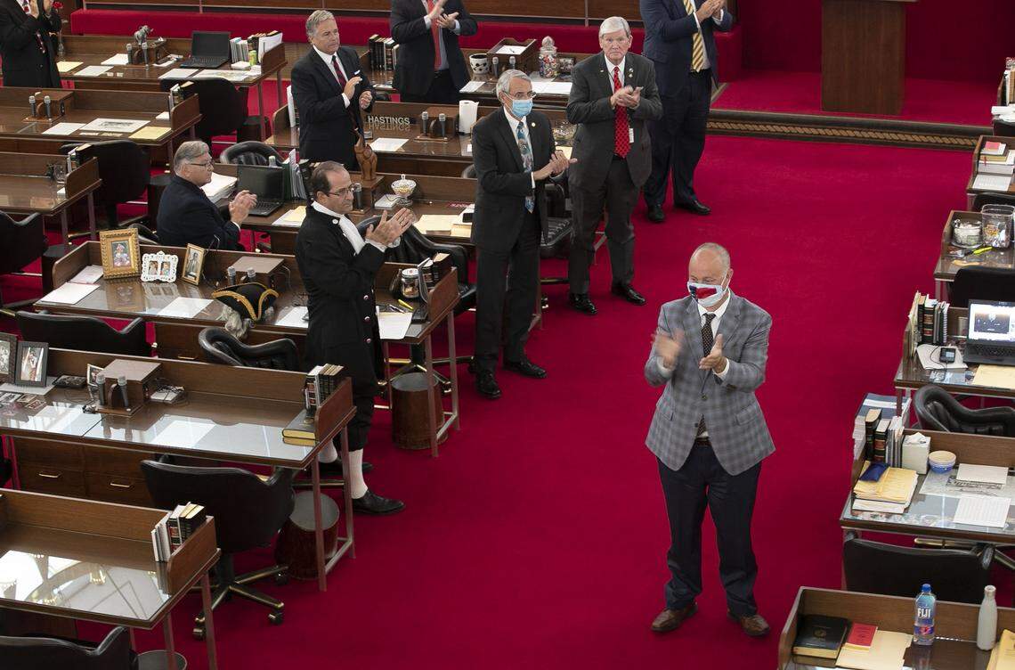 Rep. Darren Jackson of Wake County leads members in attendance in a round of applause for new members of the House during their session on Tuesday, April 28, 2020 in Raleigh, N.C.