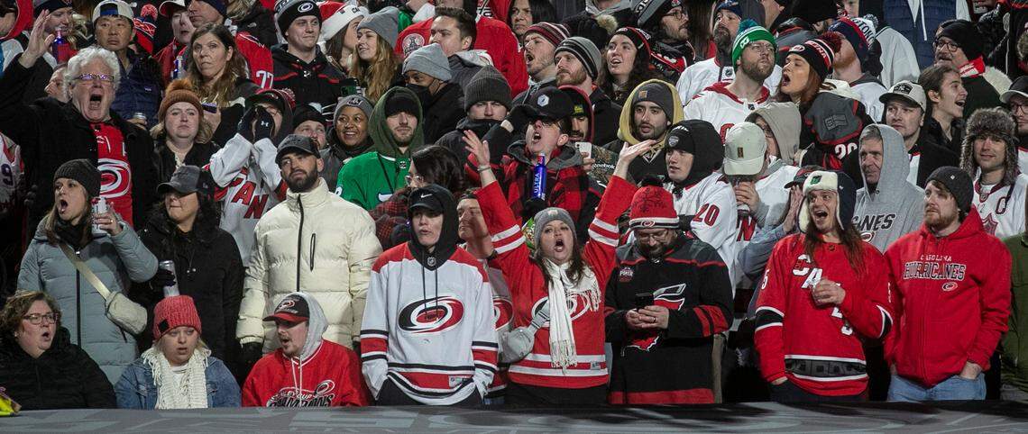 Carolina Hurricanes fans celebrate after a goal by Teuvo Teravainen (86) in the second period against the Washington Capitals in the Stadium Series game on Saturday, February 18, 2022 at Carter-Finley Stadium in Raleigh, N.C.