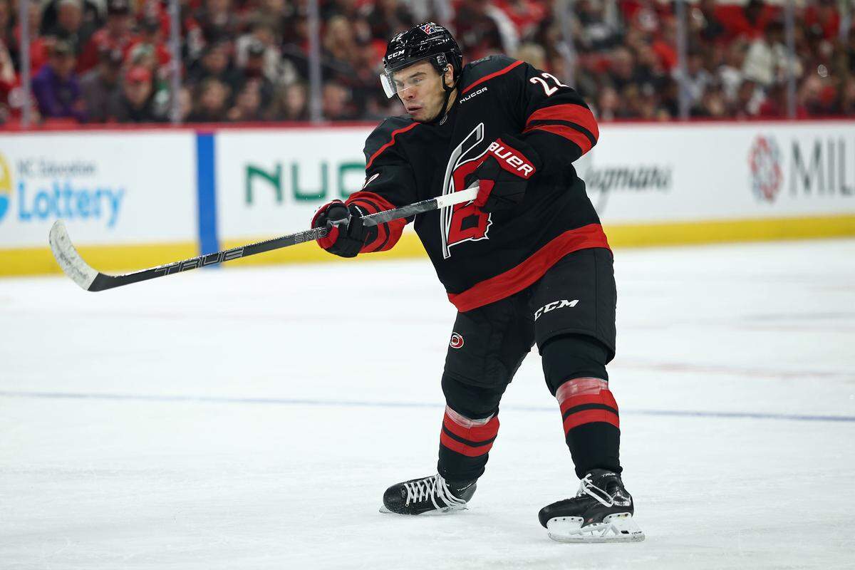 Logan Stankoven of the Carolina Hurricanes attempts a shot during the second period of the game against the New Jersey Devils at Lenovo Center on Oct. 9, 2025 in Raleigh, North Carolina.