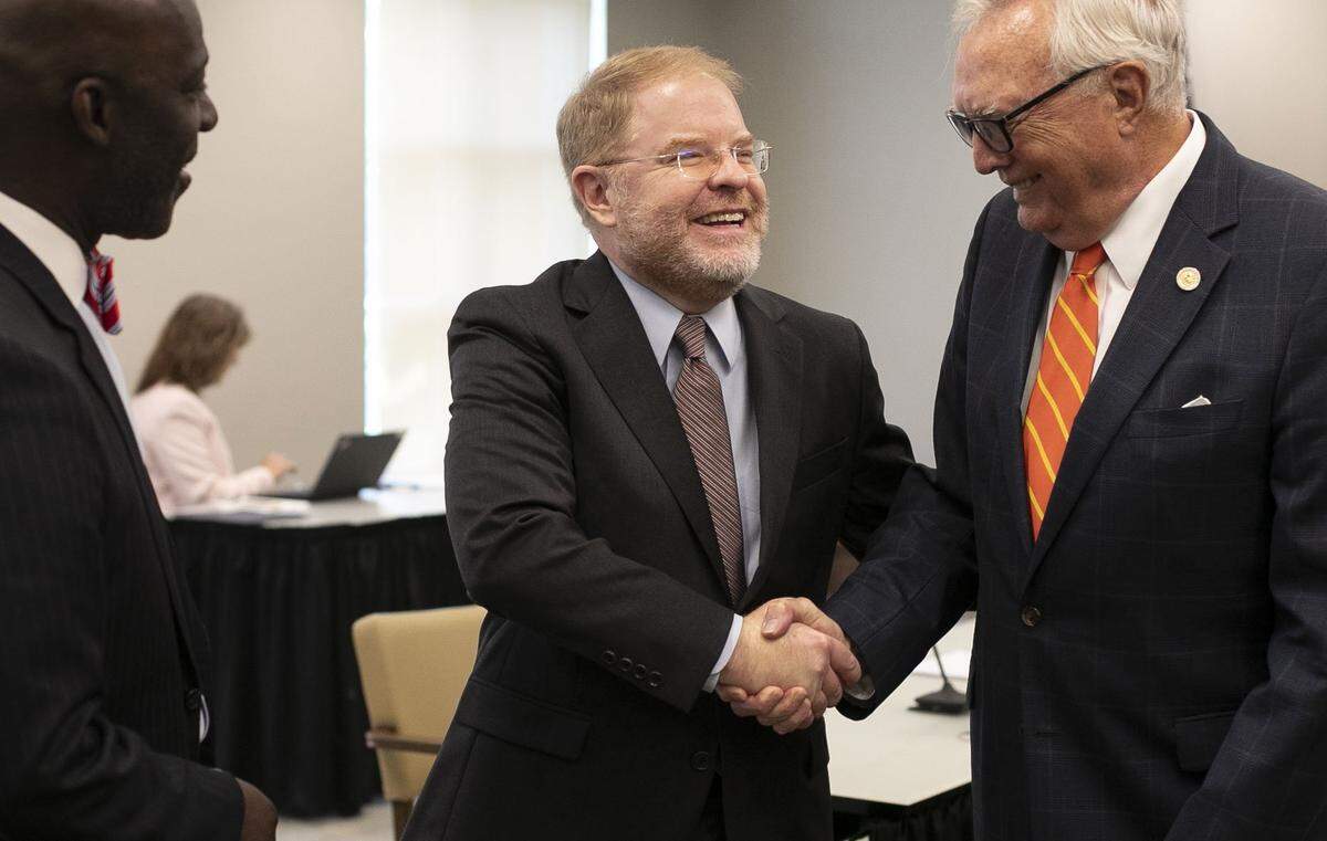 UNC System President-elect Peter Hans shakes hands with Board of Governors member Leo Daughtry following their meeting meeting on Friday, June 19, 2020 in Chapel Hill, N.C.