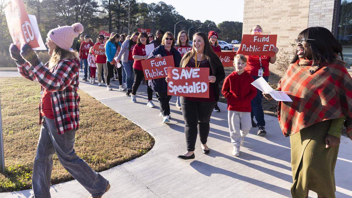 Educators and parents picket outside Fuquay-Varina Elementary School on Thursday, March 19, 2026, during a demonstration organized by the Wake County affiliate of the North Carolina Association of Educators. Protesters urged Wake County school leaders to prevent budget cuts that would reduce spending on special education programs.