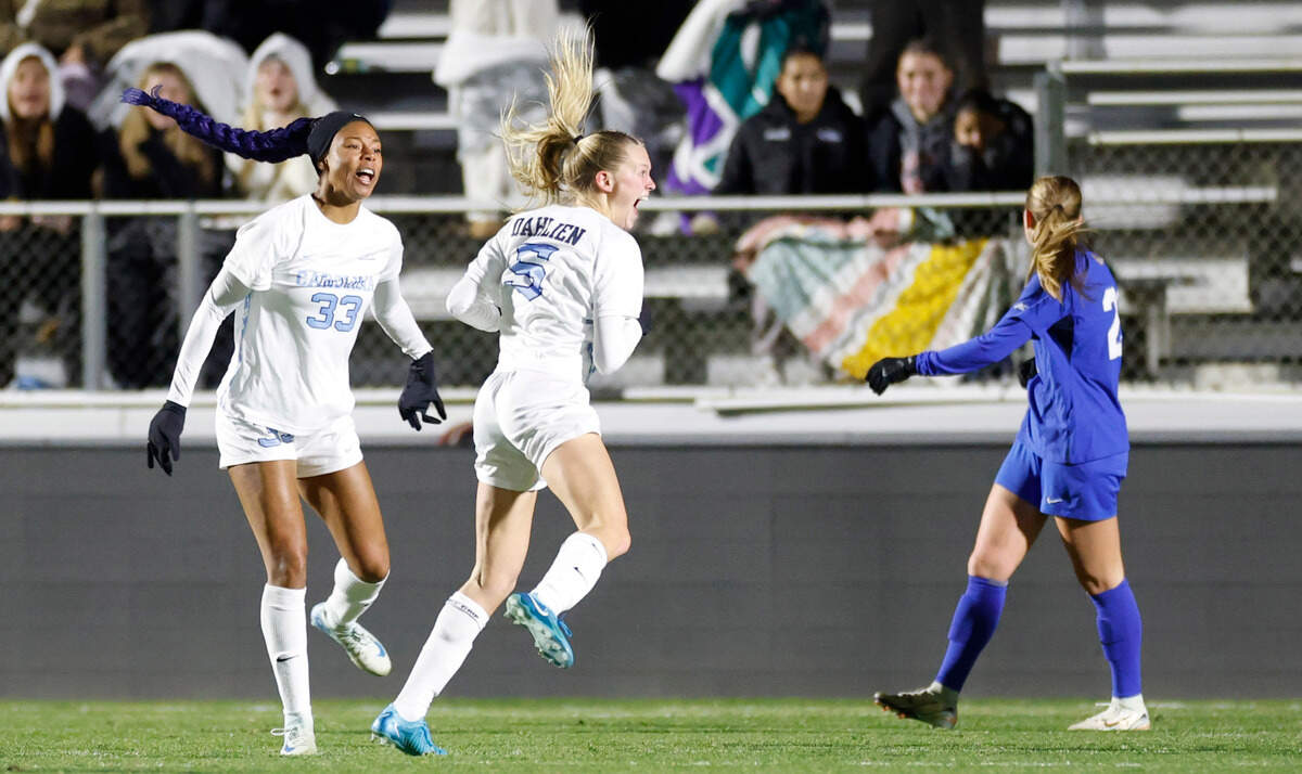 North Carolina’s Maddie Dahlien (5) and Olivia Thomas (33) celebrate after Dahlien scored in the second half of UNC’s 3-0 victory over Duke in the semifinals of the 2024 Women’s College Cup at WakeMed Soccer Park in Cary, N.C., Friday, Dec. 6, 2024.