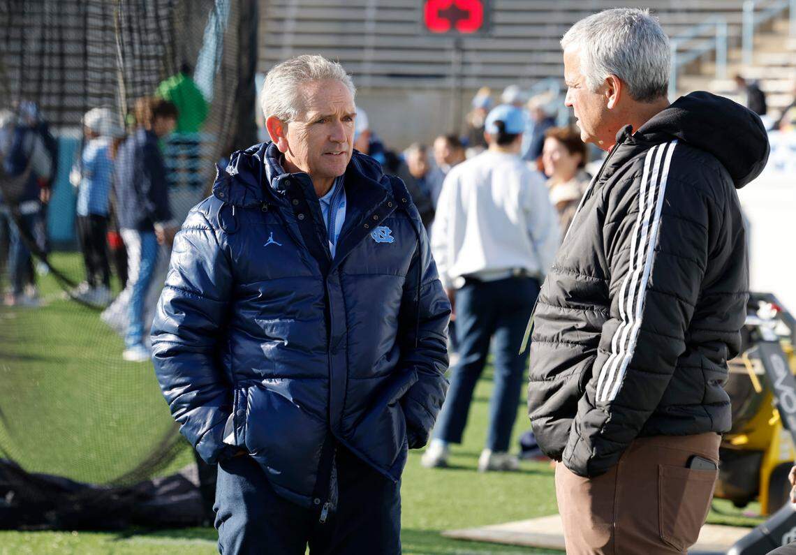 North Carolina athletic director Bubba Cunningham talks with N.C. State athletic director Boo Corrigan before N.C. State’s game against UNC at Kenan Stadium in Chapel Hill, N.C., Saturday, Nov. 30, 2024.