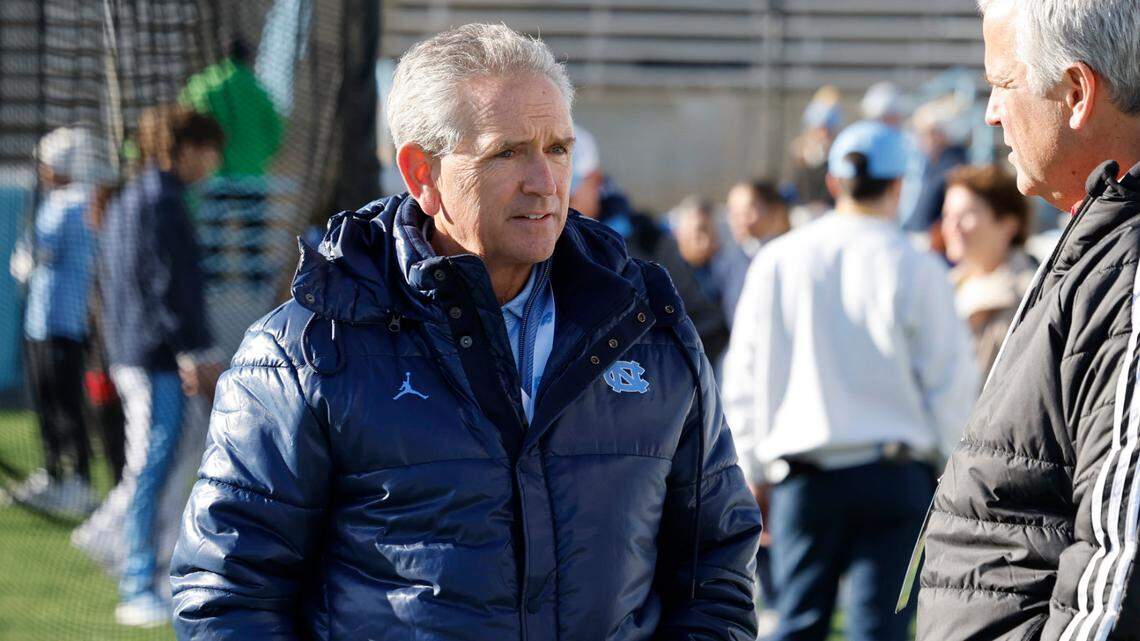 North Carolina athletic director Bubba Cunningham talks with N.C. State athletic director Boo Corrigan before N.C. State’s game against UNC at Kenan Stadium in Chapel Hill, N.C., Saturday, Nov. 30, 2024.