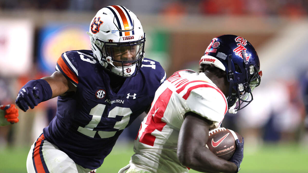Auburn Tigers linebacker Cam Riley (13) closes in on Mississippi Rebels running back Ulysses Bentley IV (24) during the fourth quarter of an October game at Jordan-Hare Stadium. / John Reed-USA TODAY Sports