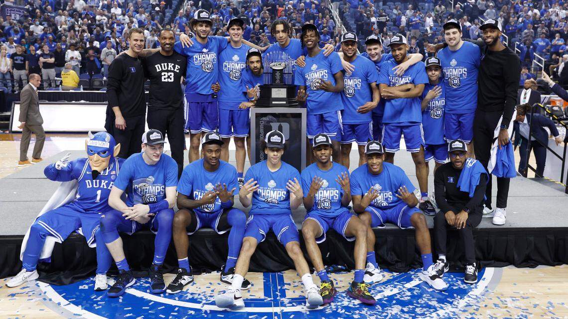 The Blue Devils pose with the championship trophy after the Blue Devils’ 59-49 victory over Virginia to win the ACC Men’s Basketball Tournament in Greensboro, N.C., Saturday, March 11, 2023.