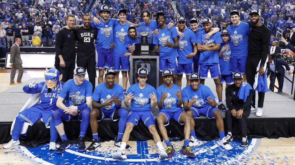 The Blue Devils pose with the championship trophy after the Blue Devils’ 59-49 victory over Virginia to win the ACC Men’s Basketball Tournament in Greensboro, N.C., Saturday, March 11, 2023.