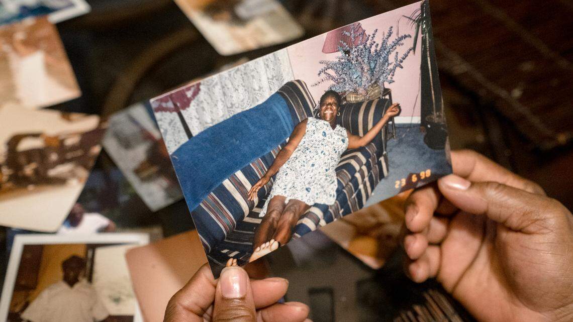 Angela Howze, Lisa Howze, and Earlene Howze look at photos of their mother, Palestine Howze, at Lisa’s home in Durham, NC, on Thursday December 10th, 2020.