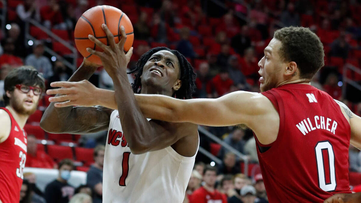 N.C. State’s Dereon Seabron (1) is fouled by Nebraska’s C.J. Wilcher (0) during N.C. State’s 104-100 victory over Nebraska in four overtimes at PNC Arena in Raleigh, N.C., Wednesday, December 1, 2021.