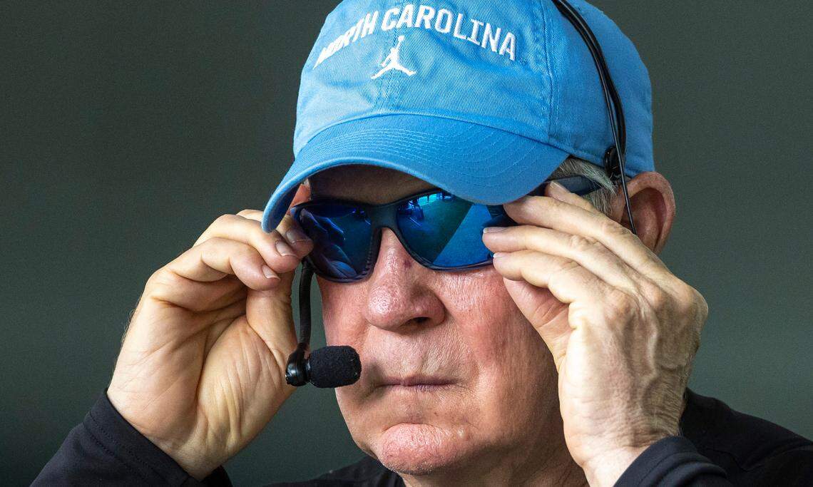 North Carolina coach Mack Brown slips on his sunglasses as he heads outside during the first day of practice on Wednesday, August 2, 2023 in Chapel Hill, N.C.