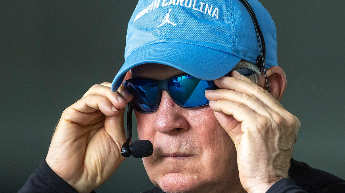 North Carolina coach Mack Brown slips on his sunglasses as he heads outside during the first day of practice on Wednesday, August 2, 2023 in Chapel Hill, N.C.