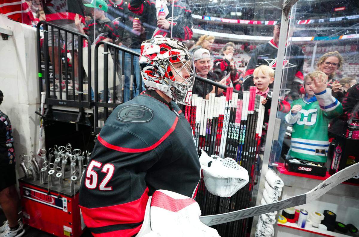 Carolina Hurricanes goaltender Pyotr Kochetkov (52) goes past the fans on his way to the warmups before the game against the New Jersey Devils in game two of the first round of the 2025 Stanley Cup Playoffs at Lenovo Center.