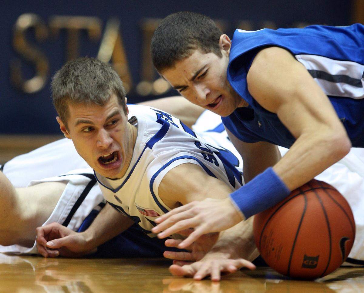 Duke guard Jon Scheyer (30) and North Carolina-Asheville guard Matt Dickey (2) battle for the ball during first half action at Cameron Indoor Stadium in Durham, North Carolina, Wednesday, December 17, 2008.