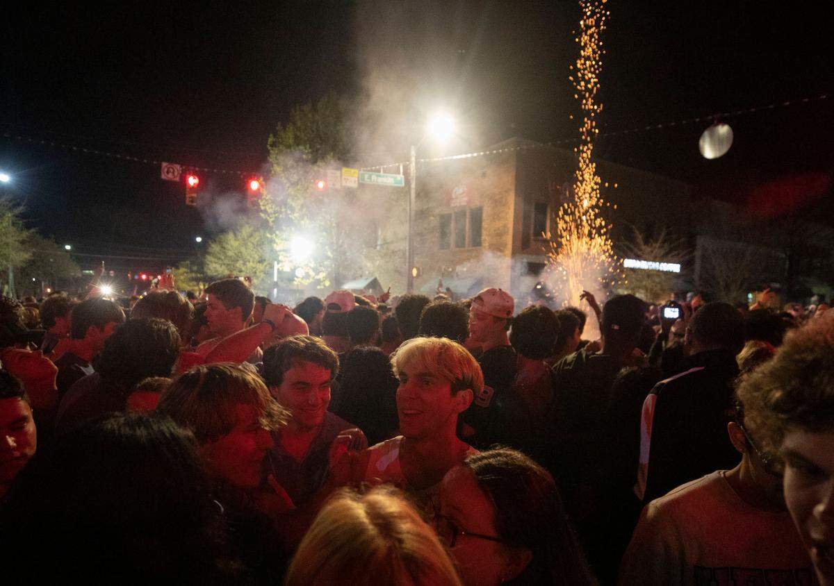 Tar Heel fans set off fireworks while celebrating in the streets of downtown Chapel Hill, N.C. after a historic Final Four win against their rival, Duke, on Saturday, April 2, 2022.