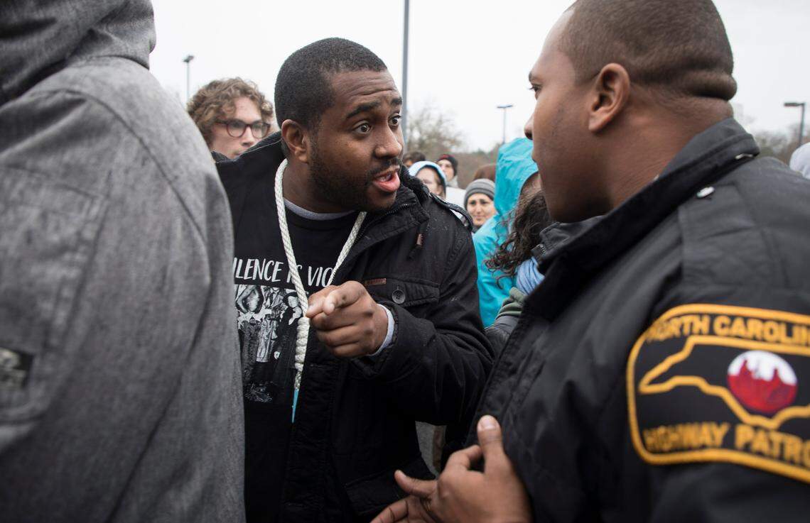 Graduate student Jerry Wilson, who has said he will wear a noose around his neck until the Board of Trustees rescinds their plan to house Silent Sam in a new building on campus, argues with law enforcement about their approach to protesters on Friday, Dec. 14, 2018.