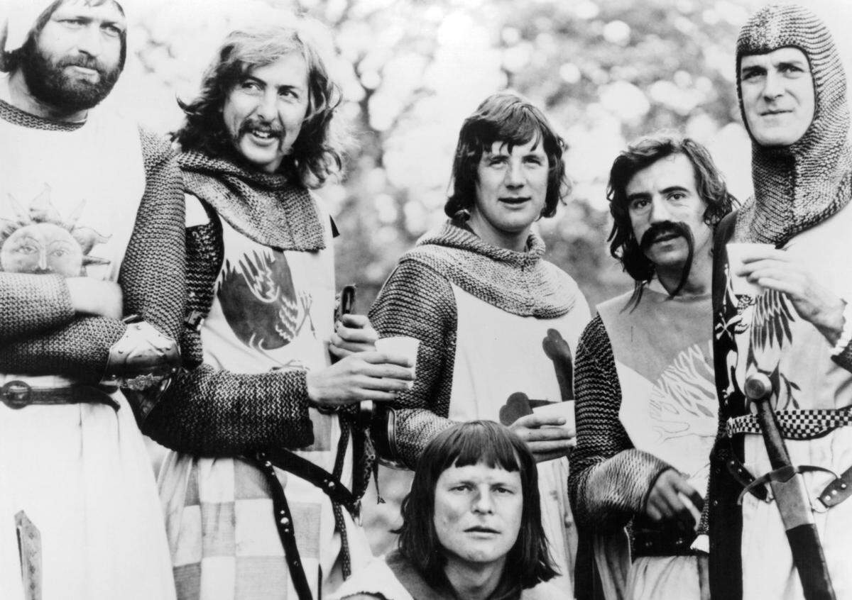 Graham Chapman, Eric Idle, Terry Gilliam, Michael Palin, Terry Jones, and John Cleese standing together in a scene from the film 'Monty Python And The Holy Grail' in 1975. 