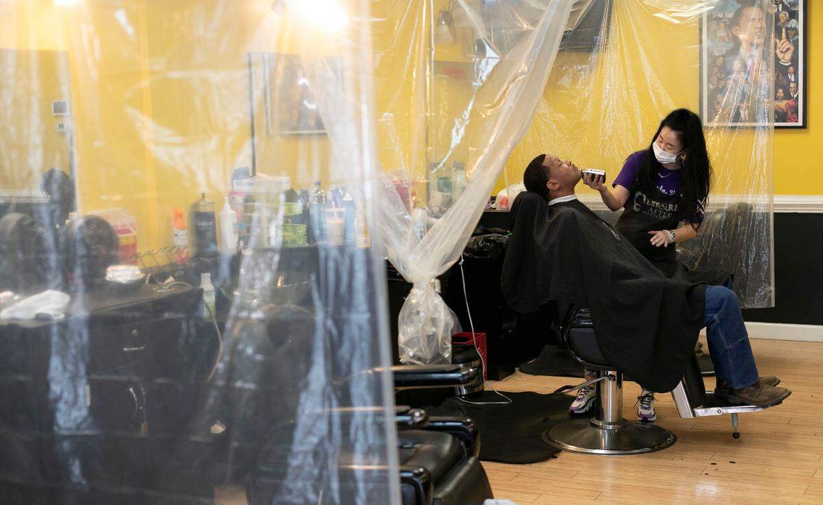 ‘True the Barber’ works with customer Bryson Thaxton at Before & After Barbershop on Poole Road in Raleigh on Thursday, March 25, 2021.