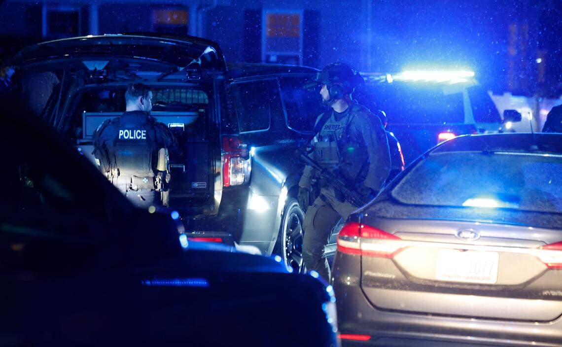 Officers walk near Chapanoke Road after responding to a shooting in the 600 block of Democracy Street in Raleigh, N.C., Tuesday evening, Jan. 21, 2025.