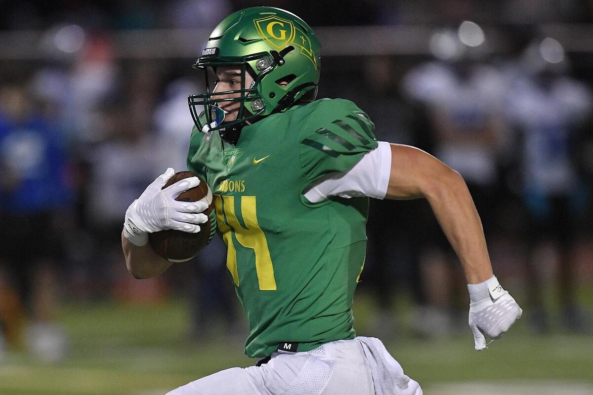 Cardinal Gibbons’ Chet Yardley (14) sprints for the touchdown during the first half. The Clayton Comets and the Cardinal Gibbons Crusaders met in the third round of the NCHSAA 4A Football Playoffs in Raleigh, N.C. on November 17, 2023.