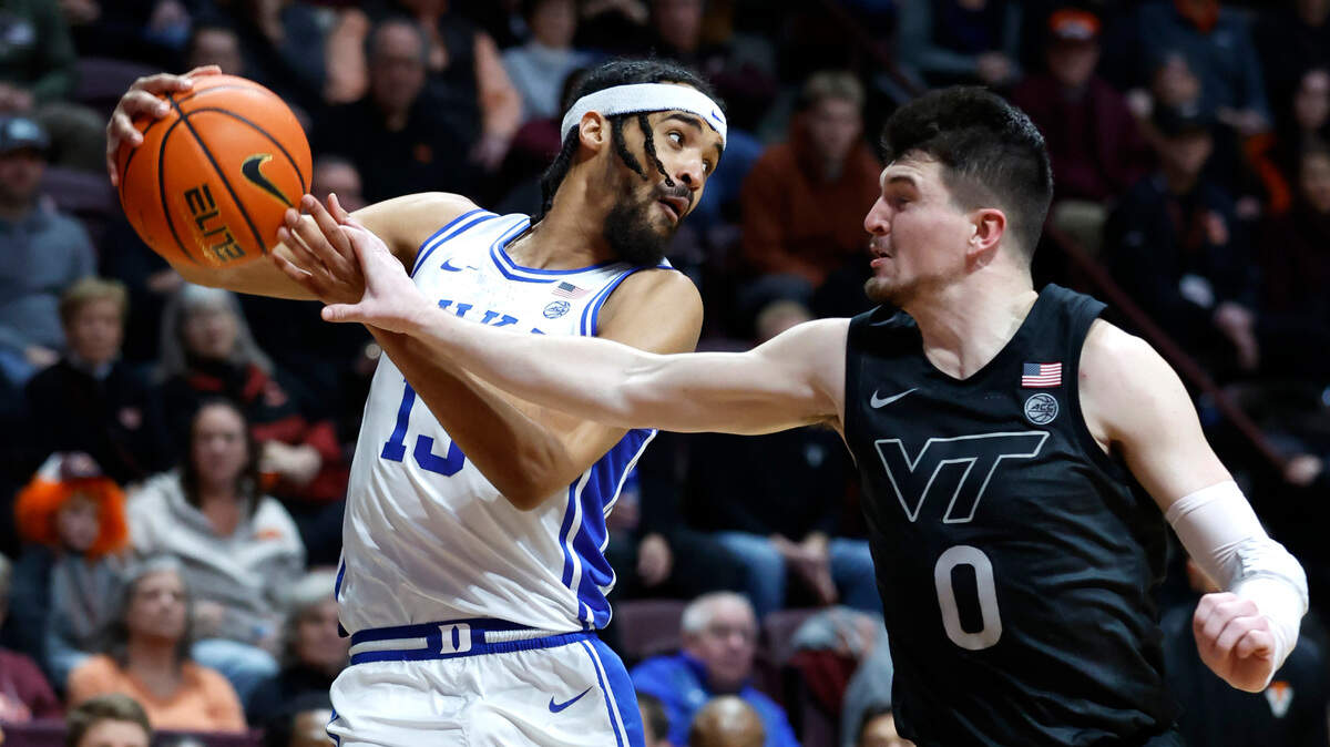 Duke’s Jacob Grandison (13) keeps the ball from Virginia Tech’s Hunter Cattoor (0) during the first half of Duke’s game against Virginia Tech at Cassell Coliseum in Blacksburg, VA., Monday, Jan. 23, 2023.