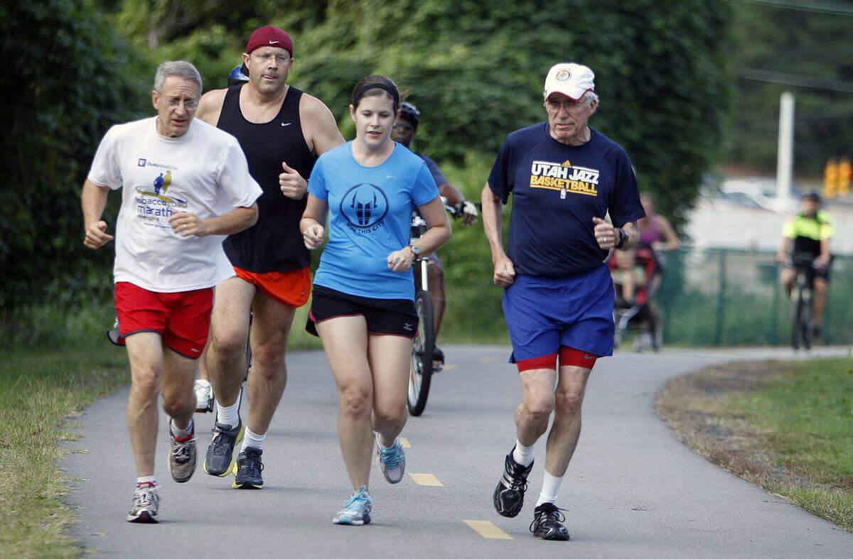 Durham City Councilman Steve Schewel, left, runs with a pack of other Durham area joggers and cyclists about one half mile from the start of the American Tobacco Trail Tuesday evening, August 28, 2012. In response to recent attacks on the American Tobacco Trail in Durham, Schewel invites the public to jog or cycle with him on a five mile trail circuit Tuesday evenings for the next month, starting at 630PM at Mile 0. Tuesday was the first day of the month long event.