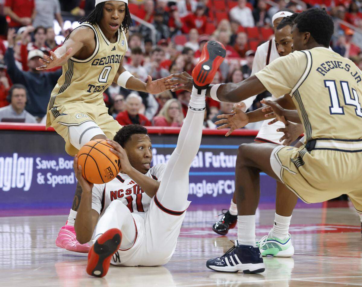 N.C. State’s Quadir Copeland looks to pass around Georgia Tech’s Akai Fleming and Kowacie Reeves Jr. during the second half of the Wolfpack’s 78-74 loss on Saturday, Jan. 17, 2026, at Lenovo Center in Raleigh, N.C. 