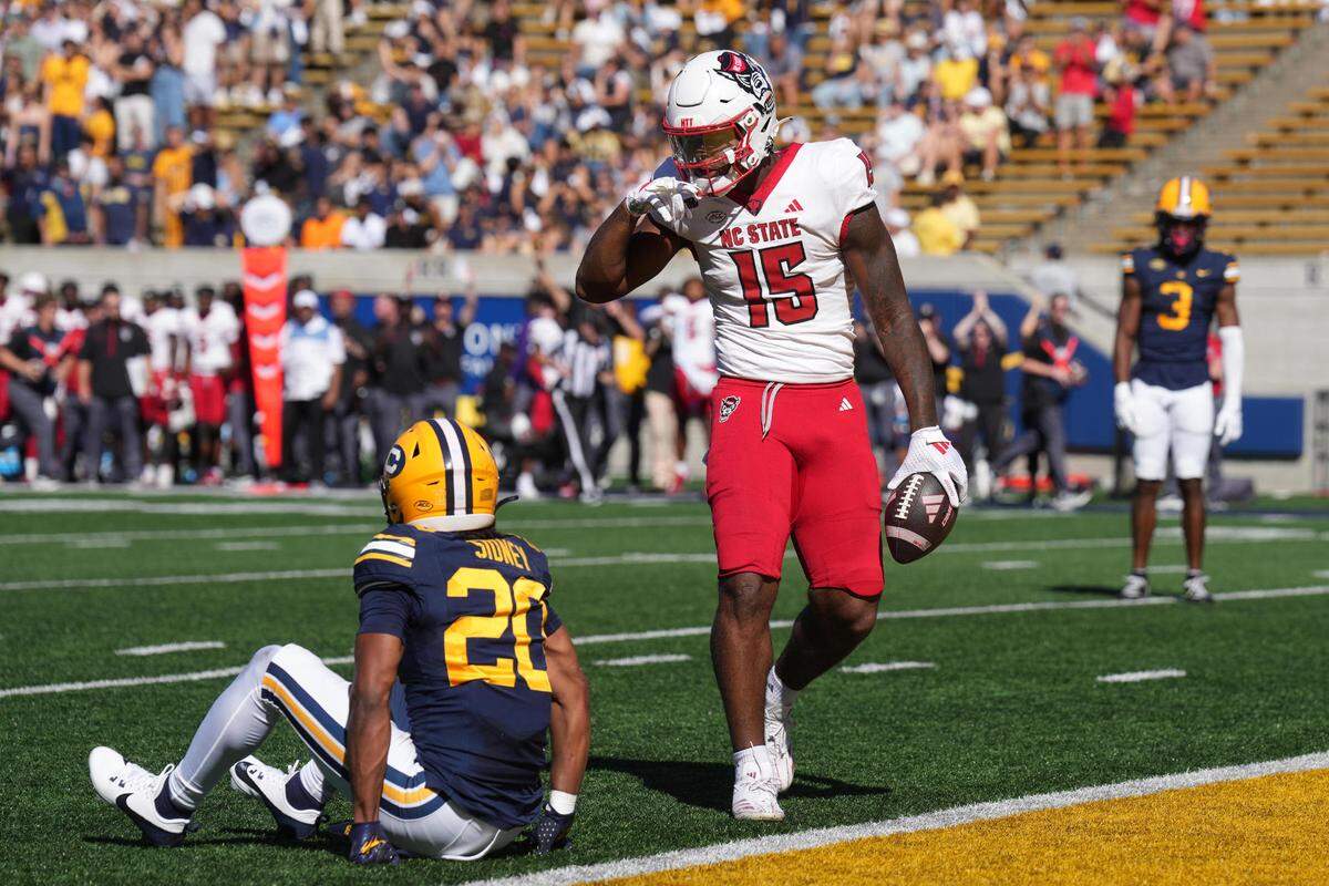 North Carolina State Wolfpack tight end Justin Joly (15) gestures after catching a pass against California Golden Bears defensive back Cam Sidney (20) during the second quarter at California Memorial Stadium.