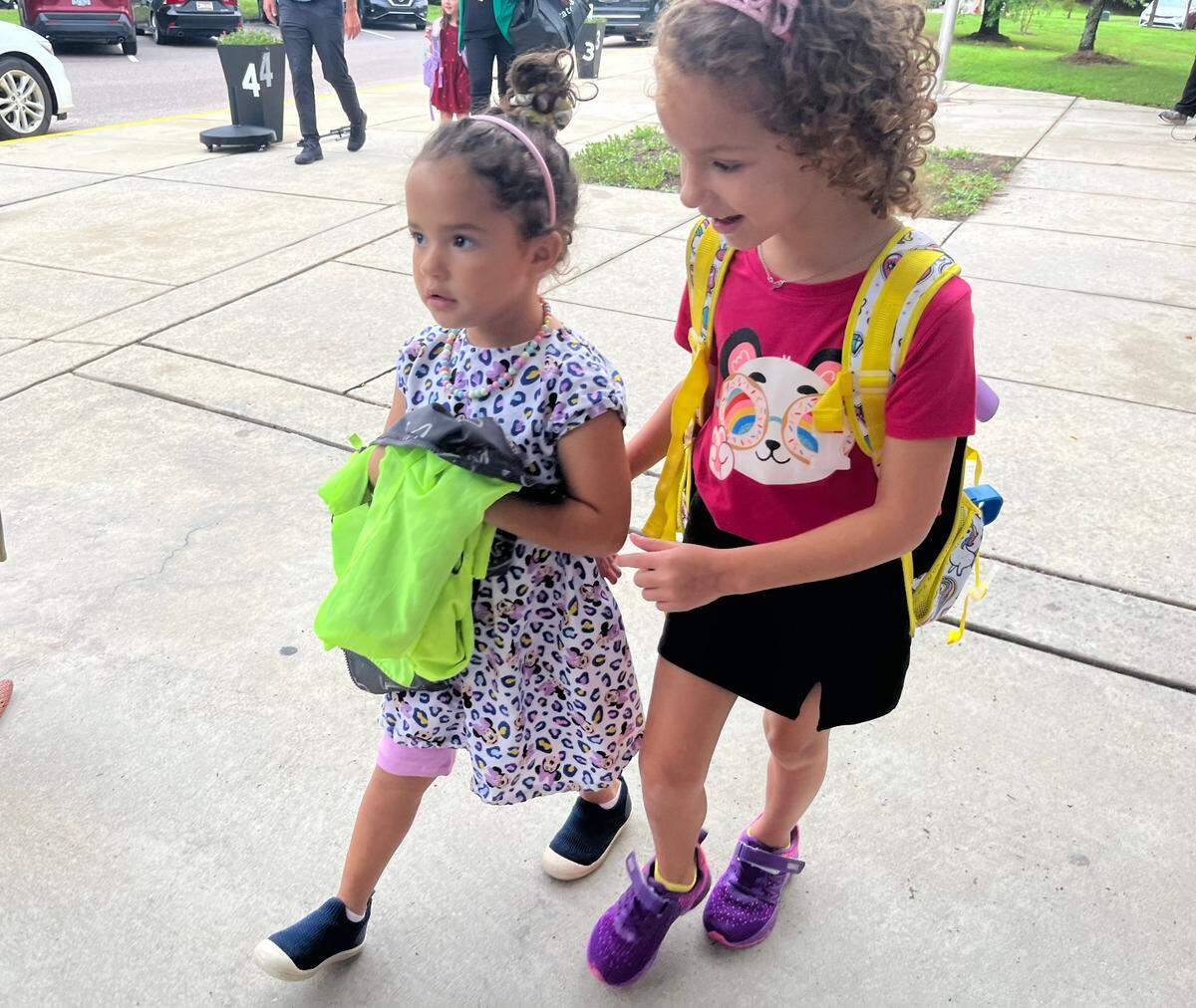Students walk in on the first day of year-round school at W.G. Pearson Elementary in Durham, N.C. on Monday, July 22, 2024.