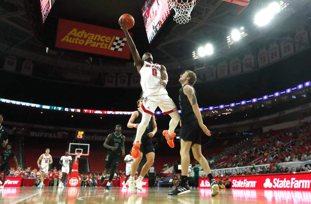 N.C. State’s DJ Horne (0) heads to the basket as Mount Olive’s Redford Dunton (15) watches during N.C. State’s 89-76 exhibition victory over Mount Olive at PNC Arena in Raleigh, N.C., Wednesday, Nov. 1, 2023.