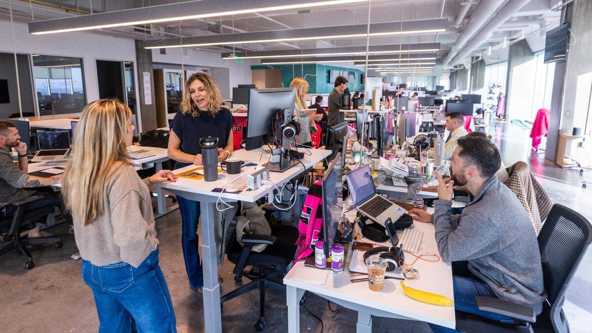 Pendo employees work in an open office workspace inside the Pendo building in downtown Raleigh.