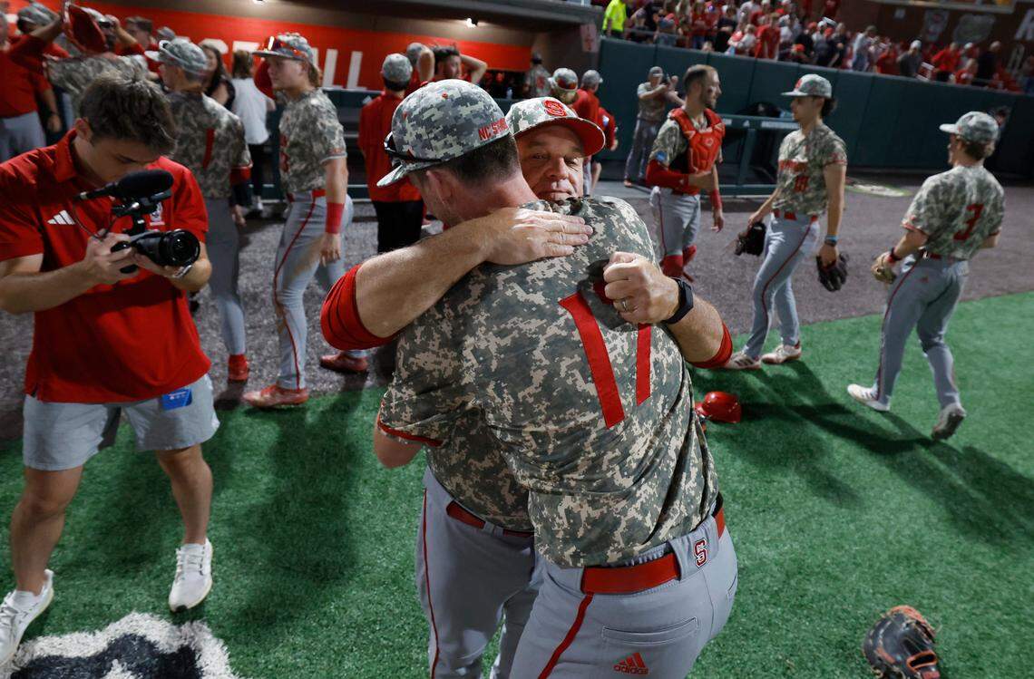 N.C. State head coach Elliott Avent hugs Sam HIghfill (17) after N.C. State’s 5-3 victory over James Madison in the NCAA Raleigh Regional final at Doak Field Sunday, June 2, 2024.