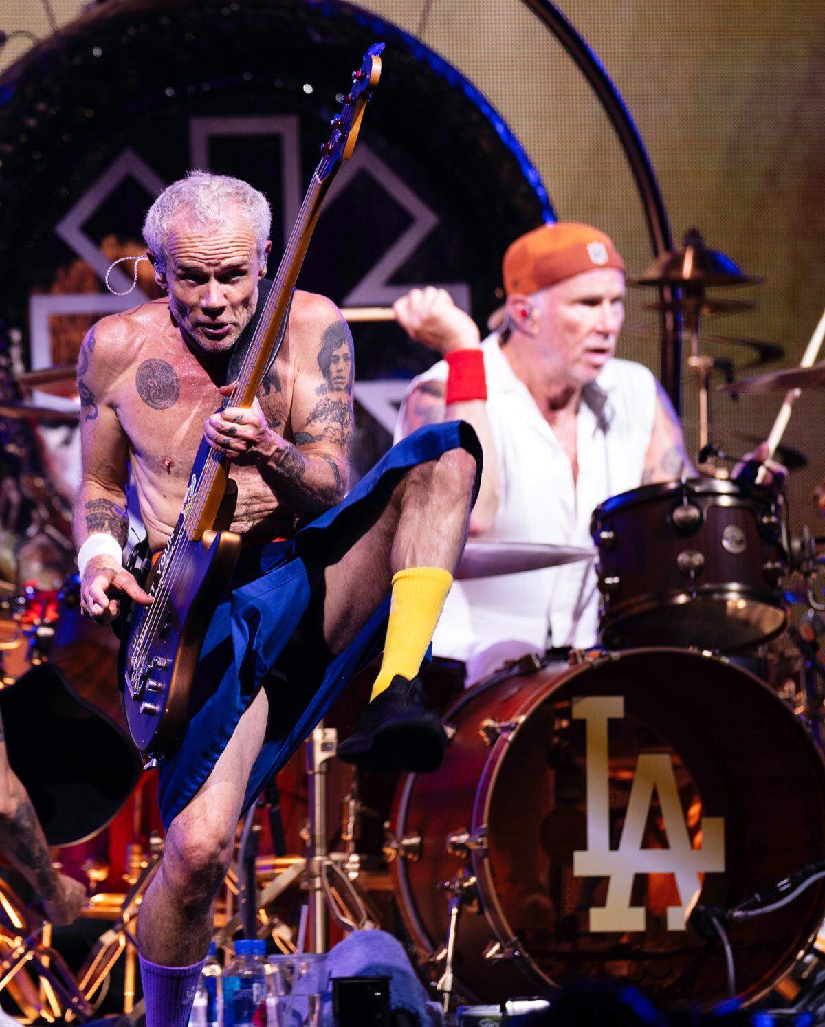 Red Hot Chili Peppers bassist Flea does one of his signature leaps during their concert in Raleigh, Wednesday night, June 26, 2024.